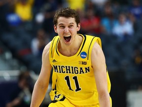 Nik Stauskas of the Michigan Wolverines celebrates after making a shot against the Florida Gators at Dallas Cowboys Stadium. (Photo by Tom Pennington/Getty Images)