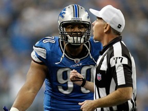 Lions defensive end Ndamukong Suh, left, argues with referee Terry McAulay against the Green Bay Packers. (Photo by Gregory Shamus/Getty Images)