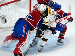 Boston's Carl Soderberg, centre, is sandwiched between Montreal goalie Carey Price, left, and David Desharnais Tuesday. (THE CANADIAN PRESS/Ryan Remiorz)