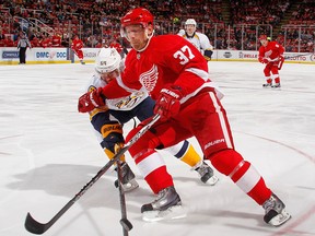 Detroit's Mikael Samuelsson, right, is checked by Nashville's Victor Bartley. (Photo by Gregory Shamus/Getty Images)