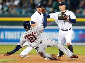 Houston's Dexter Fowler, left, tries to distract Detroit second baseman Ian Kinsler as he throws to complete a double play on a Jason Castro ground ball in the sixth inning Wednesday. (AP Photo/Paul Sancya)
