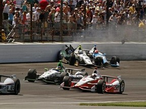 Ed Carpenter (20) and James Hinchcliffe, (27) of Canada, crash in the first turn during the 98th running of the Indianapolis 500 IndyCar auto race at the Indianapolis Motor Speedway in Indianapolis, Sunday, May 25, 2014. (AP Photo/Steve Metz)