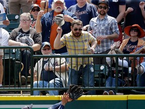 Houston right-ielder George Springer misplays an RBI double by Detroit's Nick Castellanos during the second inning in Detroit Thursday. (AP Photo/Carlos Osorio)