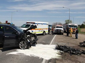 Emergency crews work at the scene of a motor vehicle collision on Howard Ave. near the Dougall Parkway overpass, Saturday, May 10, 2014.  Two people were taken to hospital with unknown injuries.  (DAX MELMER/The Windsor Star)