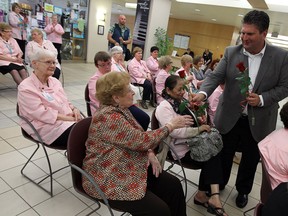 David Musyj president and CEO of Windsor Regional Hospital, presents roses to those in attendance during a service to mark the 80 years of the Windsor Regional Hospital Auxiliary at Windsor Regional Hospital in Windsor on Monday, May 12, 2014.             (TYLER BROWNBRIDGE/The Windsor Star)