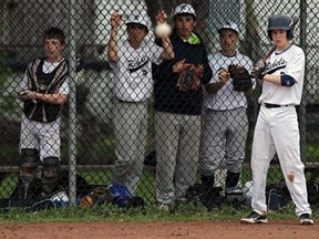 Riverside players watch the ball fly from the dugout as they take on Massey during high school baseball action at Riverside Baseball in Windsor on Friday, May 9, 2014. (TYLER BROWNBRIDGE/The Windsor Star)