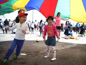 In this file photo, kids play under a colourful parachute. Monday, May 19, 2014.  (DAX MELMER/The Windsor Star)