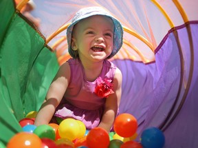 Sara Renaud, 1, has a ball crawling through a tube filled with balls at the City's 122nd Birthday Celebration at the Riverfront Festival Plaza in downtown Windsor, Monday, May 19, 2014.  (DAX MELMER/The Windsor Star)