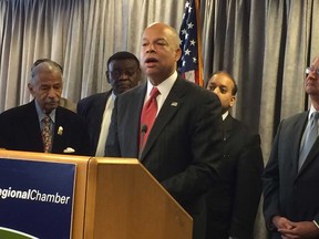 In this file photo, Homeland Security Secretary Jeh Johnson speaks at the podium with U.S. Rep John Conyers, left.  (Dave Battagello/The Windsor Star)