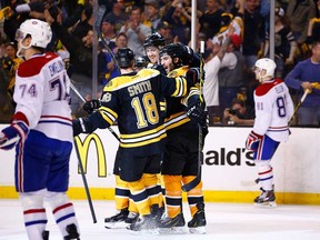 Boston's Dougie Hamilton, centre, celebrates his goal in the third period with teammates Patrice Bergeron, right, and Reilly Smith against the Montreal Canadiens in Game 2 at TD Garden on May 3, 2014 in Boston, Massachusetts.  (Photo by Jared Wickerham/Getty Images)