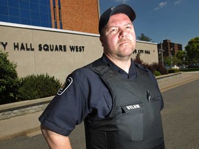 Todd Hamilton, a bylaw enforcement officer, wears a Kevlar body armor outside City Hall in downtown Windsor, Friday, May 30, 2014.    (DAX MELMER/The Windsor Star)