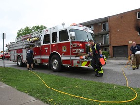 A body was discovered inside an apartment unit in the 1000 block of California Avenue following a fire on Monday, May 12, 2014. Windsor Fire Service personnel are shown at the scene. (DAN JANISSE/The Windsor Star)