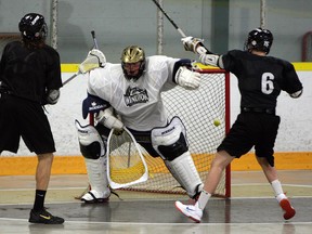 Windsor's Cooper Cecile, centre, makes a save at practice at Forest Glade Arena last year. (TYLER BROWNBRIDGE/The Windsor Star)