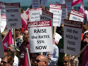 CUPE members carry signs during a CUPE rally at the Festival Plaza in Windsor on Friday, May 30, 2014. (TYLER BROWNBRIDGE/The Windsor Star)