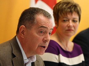 In this file photo, Dave Cooke of the Windsor-Essex mega hospital steering committee speaks in this Dec. 2012 image. Windsor West MPP Teresa Piruzza looks on. (Tyler Brownbridge / The Windsor Star)