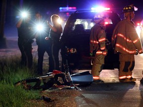 OPP and Essex firefighters investigate a serious accident involving a motorcycle on County Road 50 at Windsor Ave. at Seymour Beach Friday May 30, 2014. (NICK BRANCACCIO/The Windsor Star)