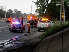 Ontario Provincial Police block off the east-bound on-ramp for EC Row Expressway on Huron Church Road, for south-bound lanes, Tuesday, May 27. According to the Windsor Fire Department, 11 gallons of oil was spilled from a truck around 5 p.m. (RICK DAWES/The Windsor Star)