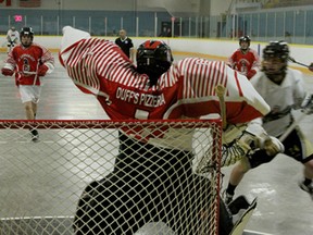 Windsor Clipper Cody Holmes, right, scores a goal in the second period of a lacrosse match against the St. Catharines Spartans, May 17, at Forest Glade Arena. (RICK DAWES/The Windsor Star)