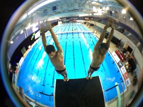 From left, Jeinkler Aguirre and JosŽ Guerra prepare to dive at the Windsor International Aquatic and Training Centre during for the FINA/NVC World Diving Series. (JASON KRYK/The Windsor Star)