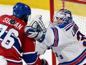 New York Rangers goalie Henrik Lundqvist, right, reaches for a loose puck around Canadiens defenceman P.K. Subban in Montreal on Saturday, May 17, 2014. (THE CANADIAN PRESS/Ryan Remiorz)