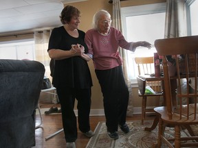 Barbara Keyes helps her 89-year-old mother Alice at their Kingsville home in Feb. 2014. (Dan Janisse / The Windsor Star)