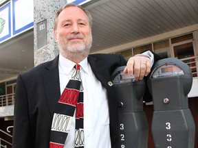 Larry Horwitz, chair of the Downtown Windsor BIA, stands alongside some parking meters in downtown Windsor on Sunday, May 4, 2014. (REBECCA WRIGHT/ The Windsor Star)