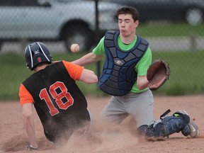 L'Essor Aigles Austyn Pitre is safe at home as Holy Names catcher Dylan McKenzie prepares to catch the baseball during the WECSSAA boys baseball game at Central Park in Windsor, Ontario on May 4, 2014. (JASON KRYK/The Windsor Star)