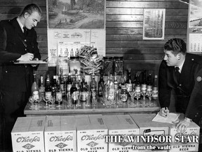 Sandwich East Police established a record for liquor raids Sunday morning when they arrested 48 persons in the basement of a house on Alexis Road. Constables Don Prosser (left) and Harley Hyland, of the Sandwich East force, check part of the liquor and beer supply and bar equipment found in the basement in this May 1, 1950 file photo. The cocktail and beer glasses seen in the picture are only a small part of the total stock. Police said a case of empty "shot glasses" was found beneath the elaborate bar. (FILES/The Windsor Star)