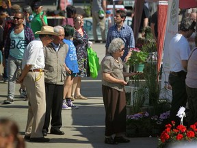 In this file photo, customers browse the various booths on the opening day of the Downtown Farmer's Market at Charles Clark Square in downtown Windsor, Saturday, May 31, 2014.  (DAX MELMER/The Windsor Star)
