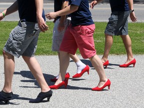 Approximately 100 people participate in the Walk a mile in Her Shoes along the Ginatchio Trail, Saturday, May 24, 2014.  The event was hosted by the Sexual Assault Crisis Centre of Windsor and Essex.  (DAX MELMER/The Windsor Star)