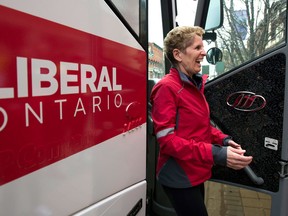 Ontario Premier Kathleen Wynne smiles as she gets off her bus at a campaign event in Milton, Ontario on Monday May 5, 2014. (Frank Gunn/The Canadian Press)