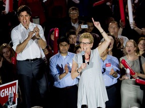 Ontario Premiere Kathleen Wynne, right, along with Liberal leader of Canada Justin Trudeau take part in a rally during a campaign stop in Toronto on Thursday, May 22, 2014. (THE CANADIAN PRESS/Nathan Denette)
