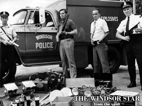 EVERYTHING BUT THE KITCHEN SINK - The city police department's new multi-purpose emergency vehicle needs only a few more items installed to be ready for action. Shown above on July 7, 1973 are some of the tools and weapons it will carry for situations ranging from a gunfight to a search for a lost child. From left are Constable Ray Sanders with a tear gas gun; Detective Barney Chrichton holding a shotgun; Detective Sergeant Sid Stuart armed with a high-power rifle; and Inspector Irv Snyder bearing a .45 calibre sub-machine gun. Equipment shown includes tear gas canisters, power saws, helmets, flares, lights, a portable generator, and various other tools. The $10,000 three-ton truck also contains a bomb disposal device. Two officers, Det. Sgt. Stuart and Det. Sgt. Jack Shuttleworth will leave this weekend for Canadian Forces Base Borden to take a three-week course in handling explosives. (Cec Southward/Windsor Star)