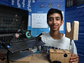 Abhi Gupta, 14, a Grade 9 student at Vincent Massey Secondary School, shows off his science experiment, an iWriter that facilitates communication for ALS patients, Friday, May 9, 2014.  Gupta's experiment will be competing at the Canada Wide Science Fair being hosted in Windsor.  (DAX MELMER/The Windsor Star)