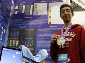 Vincent Massey Secondary School student Abhi Gupta, 14, holds up his silver medal during the 53rd Canada-Wide Science Fair at the University of Windsor St. Denis Centre Gupta's project for his project that would allow ALS patients to type with their eyes, May 16, 2014.  (RICK DAWES/The Windsor Star)