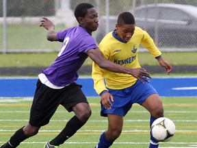Assumption's Funmibi Awo (L) and Kennedy's Matthew James-Schleifer battle for the ball during their game Friday, May 16, 2014, at the Tecumseh Vista Academy. (DAN JANISSE/The Windsor Star)