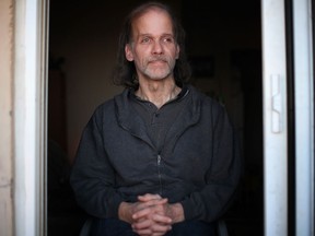Steve Reh, 50, a former resident of Southwestern Regional Centre from the age of seven to 17, looks out the window of his high-rise apartment in Windsor, Ont., Saturday, Dec. 28, 2013.  Reh is one of at least 8 plaintiffs from the Windsor area involved in a class action lawsuit launched against the province for alleged mental and physical abuse.  (DAX MELMER/The Windsor Star)