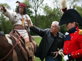 Mark Williams, centre, gives instruction David Morris, left, playing the part of Chief Tecumseh, and Scott Finlay, playing the part of Gen. Sir Isaac Brock at Paterson Park, Saturday, May 17, 2014.  Williams will be creating a statue of the two important leaders of 1812.  (DAX MELMER/The Windsor Star)