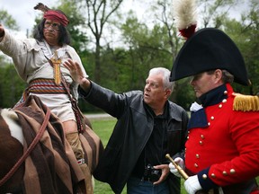 Mark Williams, centre, gives instruction David Morris, left, playing the part of Chief Tecumseh, and Scott Finlay, playing the part of Gen. Sir Isaac Brock at Paterson Park, Saturday, May 17, 2014.  Williams will be creating a statue of the two important leaders of 1812.  (DAX MELMER/The Windsor Star)