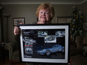 Karlene Berry, 67, a retired school teacher, holds a collage of an Aston Martin One-77 given to her by a former pupil, Michael Lehti, Friday, May 9, 2014.  Lehti graduated from Benson in 1981 and credits Berry with motivating him to success. Lehti was part of team that engineered and built the Aston Martin One-77.  (DAX MELMER/The Windsor Star)