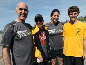 Police chief Al Frederick, Dan Martynse, Const. Cealia Gagnon and Jordon Miner (left to right) are photographed after finishing the Torch Run in Windsor on Monday, May 5, 2014. The run, which took place on the riverfront, raises awareness for the Special Olympics.                          (TYLER BROWNBRIDGE/The Windsor Star)