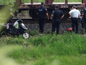 Windsor police officers investigate the death of a man on the train tracks that cross McDougall Street on May 21, 2014. (Nick Brancaccio / The Windsor Star)