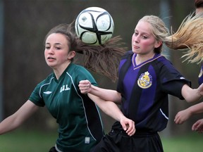Lajeunesse's Mikayla Mascatello left battles with Kingsvilles player Kennedy Ingratta during the WECSSAA  girls soccer game  in Windsor, Ontario on May 1, 2014. (JASON KRYK/The Windsor Star)
