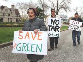 Eleanore Oncea, left, Don Nelson and Mitchell Oncea attend a rally held at Willistead Park on Saturday, May 3, 2014. Residents walked around the park protesting the construciton of new asphalt pathways, which the City of Windsor has approved. (REBECCA WRIGHT/ The Windsor Star)