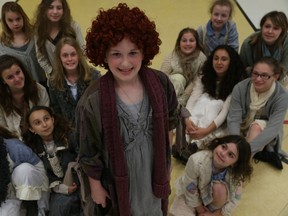 Jessica Chalmers, who plays Annie, stands with other cast members 
in the Little Tomato Theatre production of Annie Jr. (JASON KRYK / The Windsor Star)