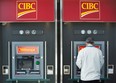 A man uses an ATM at a CIBC branch in Montreal, Thursday, April 24, 2014. (THE CANADIAN PRESS / Graham Hughes)