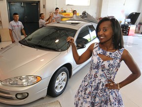 Danait Asgedom holds the keys to her new 2002 Chrysler Intrepid that was given to her by Rebuilding Wheels, Rebuilding Lives, on Friday. More than 100 students at E.J. Lajeunesse helped in the restoration of the car. (DAX MELMER / The Windsor Star)