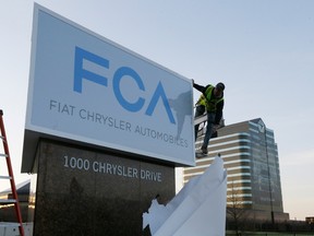 The Fiat Chrysler sign is unveiled at Chrysler World Headquarters in Auburn Hills, Mich., on Tuesday. Fiat Chrysler Automobiles NV is unveiling its business strategy for the next five years as it prepares for life as a newly merged company. (Carlos Osorio / The Associated Press)