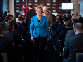 Ontario Premier and Liberal Leader Kathleen Wynne makes her way through the audience after attending the Bloomberg Economic Summit in Toronto on Tuesday. Ontario goes to the polls June 12. (Chris Young / The Canadian Press)