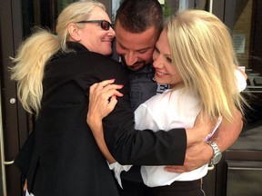 Tammy Hands, left, hugs with David Bondy and lawyer Laura Joy at Superior Court after being found not guilty of extortion and voyeurism Monday June 02, 2014. (NICK BRANCACCIO/The Windsor Star)